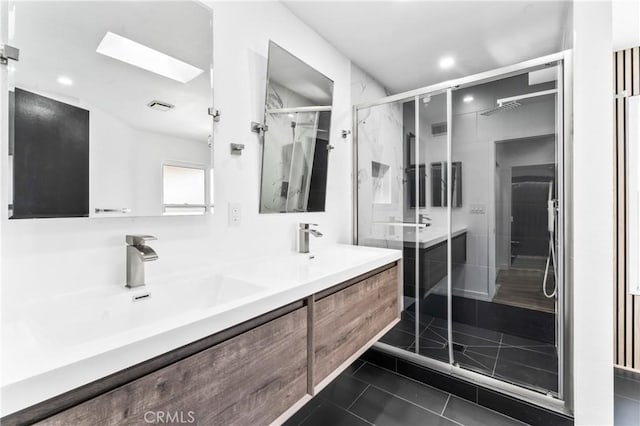 5401 Zelzah Ave Unit 114, Encino, CA 91316 - bathroom featuring double vanity, a skylight, a stall shower, recessed lighting, and tile patterned flooring