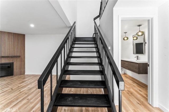 5401 Zelzah Ave Unit 114, Encino, CA 91316 - stairs with wood finished floors and a glass covered fireplace
