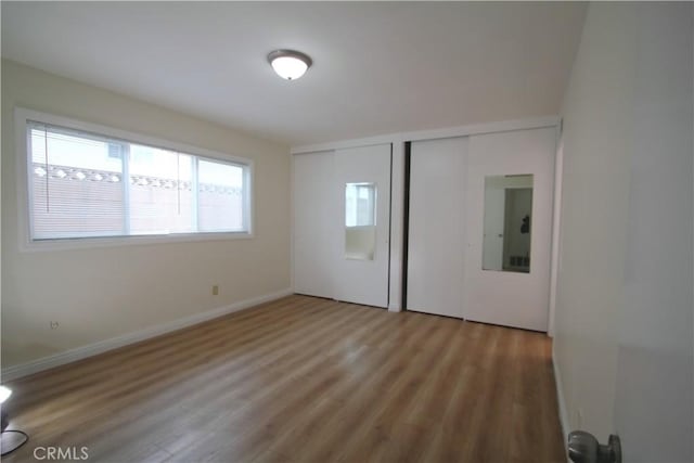 764 E Turmont St, Carson, CA 90746 - unfurnished bedroom with multiple closets and wood finished floors