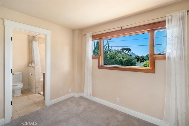 2056 Sierra Way, San Luis Obispo, CA 93401 - unfurnished bedroom featuring carpet floors, connected bathroom, and tile patterned flooring