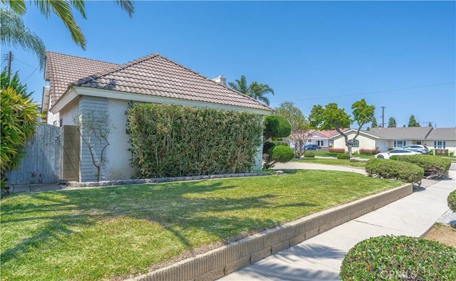 5361 Ludlow Ave, Garden Grove, CA 92845 - view of side of home featuring a tile roof, stucco siding, and a chimney