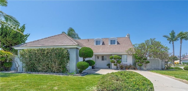 5361 Ludlow Ave, Garden Grove, CA 92845 - view of front of home featuring a chimney, a tiled roof, a front lawn, and stucco siding
