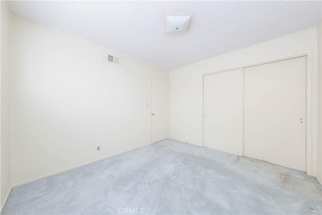 5361 Ludlow Ave, Garden Grove, CA 92845 - unfurnished bedroom with light carpet, a closet, and a textured ceiling