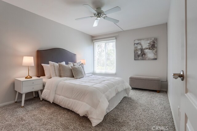 3456 Castle Glen Dr Unit 154, San Diego, CA 92123 - carpeted bedroom featuring baseboards and ceiling fan