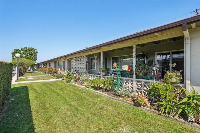 1181 Oakmont Rd Unit 197H, Seal Beach, CA 90740 - view of property exterior featuring a lawn and stucco siding
