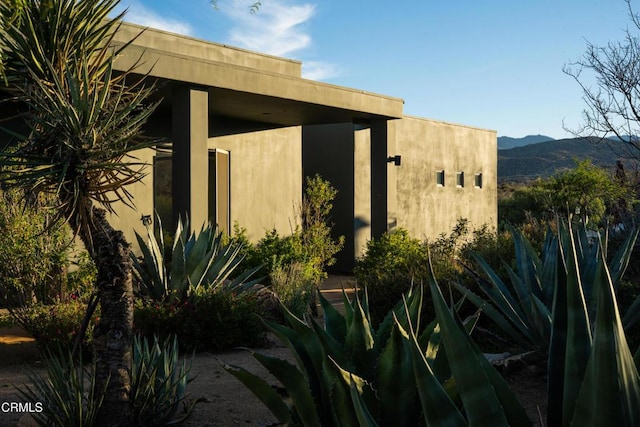 51845 Saddle Ln, Pioneertown, CA 92268 - view of side of property with a mountain view and stucco siding