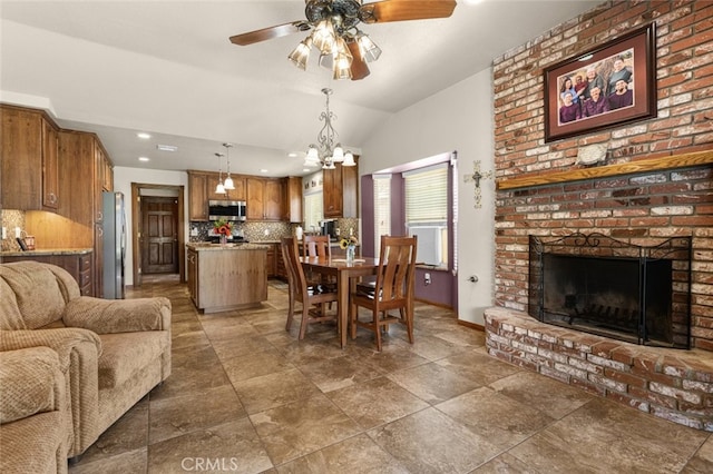 43419 37th St W, Lancaster, CA 93536 - dining area featuring vaulted ceiling, a ceiling fan, a fireplace, a chandelier, and recessed lighting