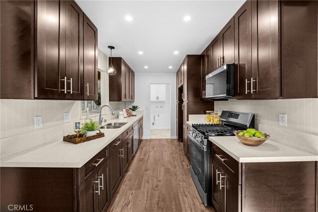 229 W Hacienda Dr, Corona, CA 92882 - kitchen featuring stainless steel appliances, light wood-style floors, dark brown cabinetry, light countertops, and recessed lighting