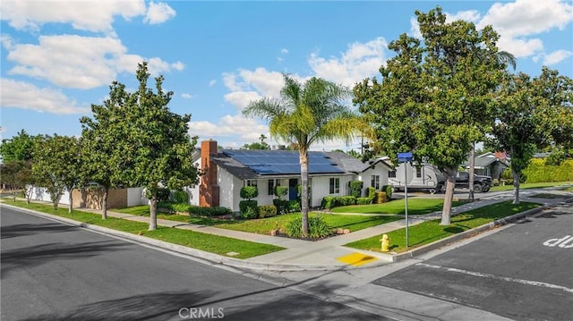 229 W Hacienda Dr, Corona, CA 92882 - single story home featuring roof mounted solar panels, a front lawn, a residential view, and uncovered parking