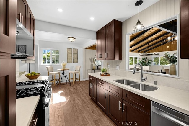 229 W Hacienda Dr, Corona, CA 92882 - kitchen with appliances with stainless steel finishes, light countertops, light wood finished floors, hanging light fixtures, and recessed lighting