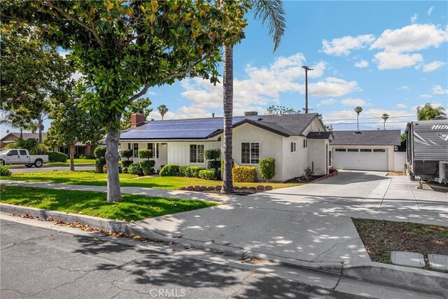 229 W Hacienda Dr, Corona, CA 92882 - ranch-style house with driveway, solar panels, a front lawn, an attached garage, and a chimney