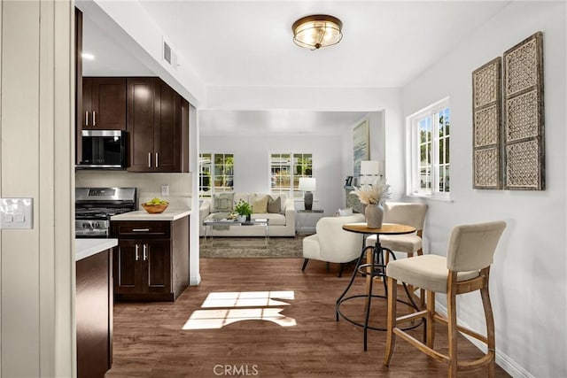 229 W Hacienda Dr, Corona, CA 92882 - kitchen with appliances with stainless steel finishes, dark wood-type flooring, light countertops, dark brown cabinets, and open floor plan