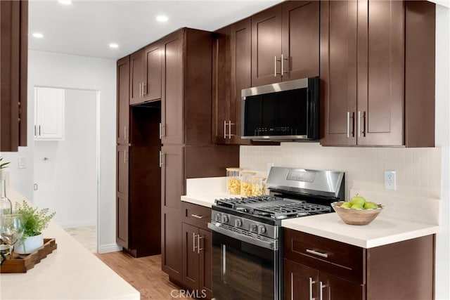 229 W Hacienda Dr, Corona, CA 92882 - kitchen with stainless steel gas stove, light wood finished floors, recessed lighting, dark brown cabinetry, and light countertops
