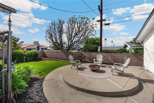 229 W Hacienda Dr, Corona, CA 92882 - fenced backyard with a patio area and an outdoor fire pit