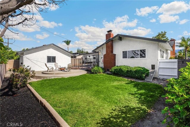 229 W Hacienda Dr, Corona, CA 92882 - rear view of property featuring a patio area, a chimney, stucco siding, and a fenced backyard