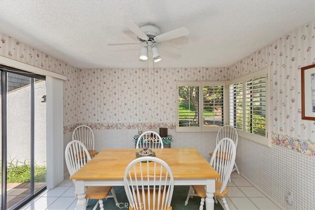 548 Via Ln, Paloma, Riverside, CA 92507 - dining space featuring wallpapered walls, a wainscoted wall, ceiling fan, light tile patterned floors, and a textured ceiling