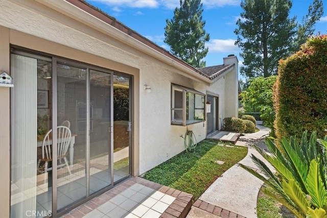 548 Via Ln, Paloma, Riverside, CA 92507 - view of home's exterior featuring stucco siding and a chimney