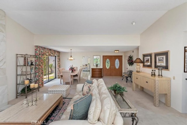 548 Via Ln, Paloma, Riverside, CA 92507 - living room with light colored carpet, healthy amount of natural light, a chandelier, and lofted ceiling