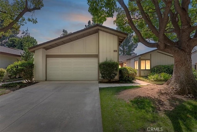 548 Via Ln, Paloma, Riverside, CA 92507 - mid-century modern home featuring driveway, a garage, and board and batten siding