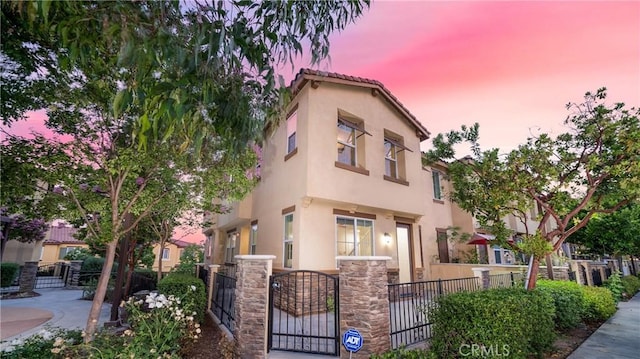 8022 Cresta Bella Rd, Rancho Cucamonga, CA 91730 - view of property with a fenced front yard, stucco siding, and a gate
