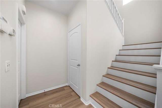 8022 Cresta Bella Rd, Rancho Cucamonga, CA 91730 - stairs featuring wood finished floors and baseboards