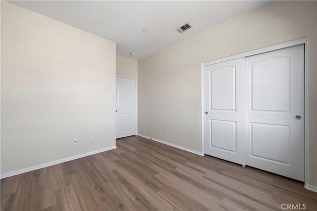 8022 Cresta Bella Rd, Rancho Cucamonga, CA 91730 - unfurnished bedroom with wood finished floors and a closet