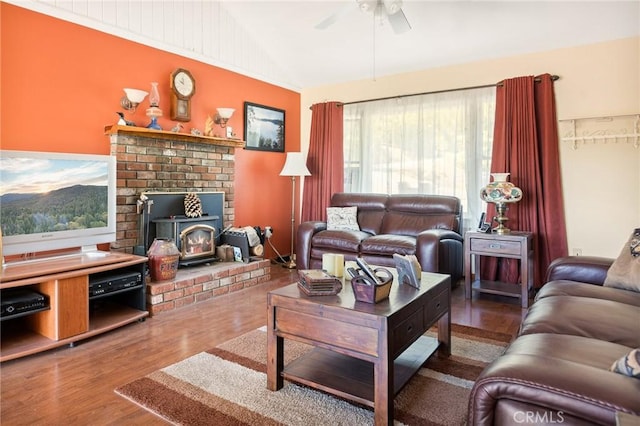 30400 Live Oak Dr, Running Springs, CA 92382 - living area featuring lofted ceiling, a wood stove, ceiling fan, and wood finished floors