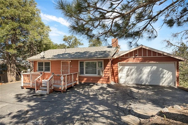 30400 Live Oak Dr, Running Springs, CA 92382 - single story home featuring a chimney, driveway, a garage, a wooden deck, and roof with shingles