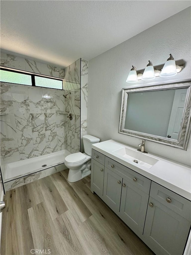 1 Paddle Ct, Sacramento, CA 95833 - full bathroom featuring vanity, a marble finish shower, wood finished floors, and a textured ceiling
