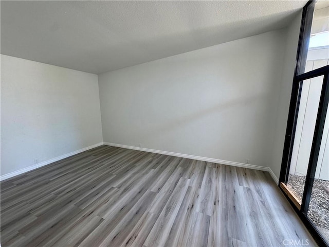 1 Paddle Ct, Sacramento, CA 95833 - empty room with wood finished floors and a textured ceiling