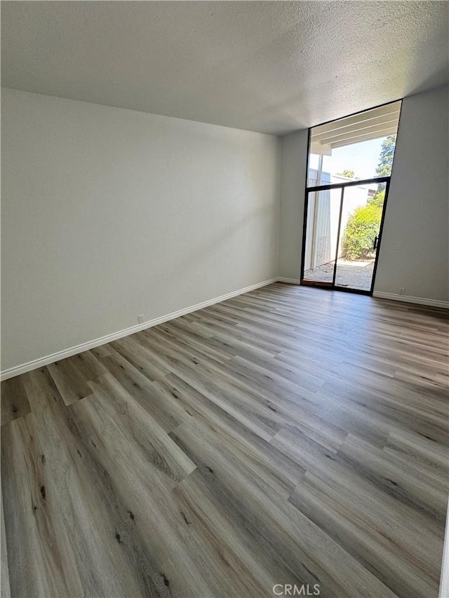 1 Paddle Ct, Sacramento, CA 95833 - unfurnished room with expansive windows, wood finished floors, and a textured ceiling