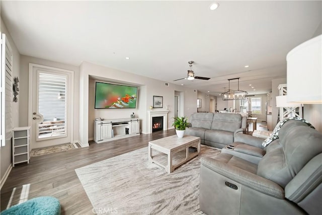 4048 Tradewinds Dr, Oxnard, CA 93035 - living area featuring a ceiling fan, wood finished floors, recessed lighting, and a lit fireplace