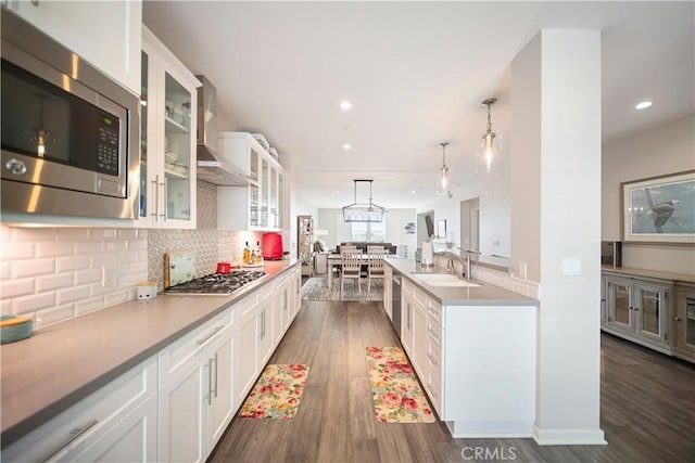 4048 Tradewinds Dr, Oxnard, CA 93035 - kitchen featuring appliances with stainless steel finishes, dark wood-style floors, backsplash, glass insert cabinets, and recessed lighting