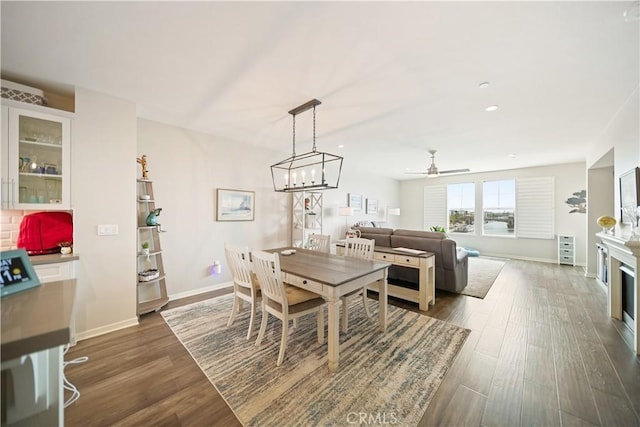 4048 Tradewinds Dr, Oxnard, CA 93035 - dining space featuring dark wood-style floors, a ceiling fan, a fireplace, and recessed lighting