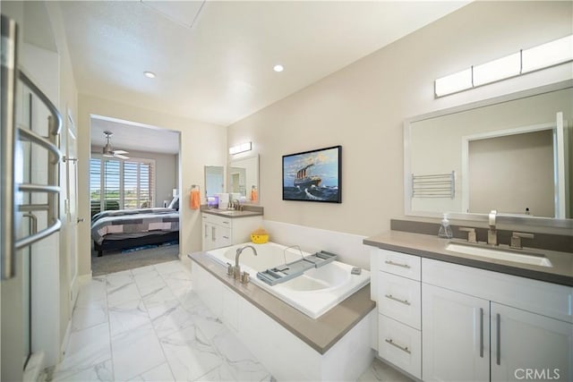 4048 Tradewinds Dr, Oxnard, CA 93035 - full bath with marble look tile flooring, a garden tub, vanity, ensuite bathroom, and recessed lighting