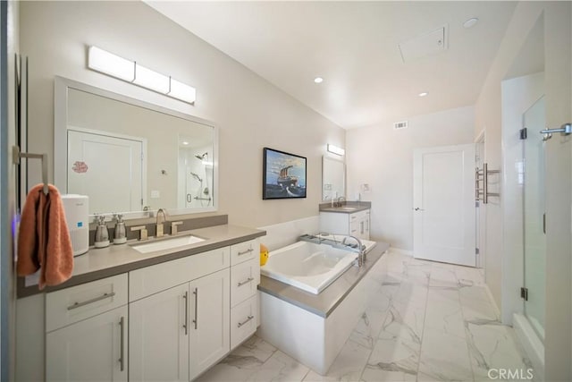 4048 Tradewinds Dr, Oxnard, CA 93035 - bathroom featuring marble look tile flooring, a bath, two vanities, a shower stall, and recessed lighting
