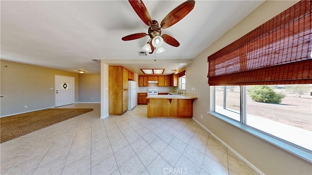 19171 Carlisle Rd, Apple Valley, CA 92307 - kitchen featuring open floor plan, freestanding refrigerator, light countertops, and a peninsula