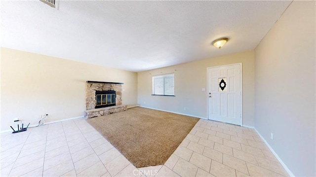 19171 Carlisle Rd, Apple Valley, CA 92307 - unfurnished living room featuring light tile patterned floors and a stone fireplace