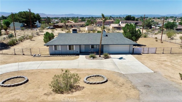19171 Carlisle Rd, Apple Valley, CA 92307 - view of front of property featuring curved driveway, a mountain view, and a garage