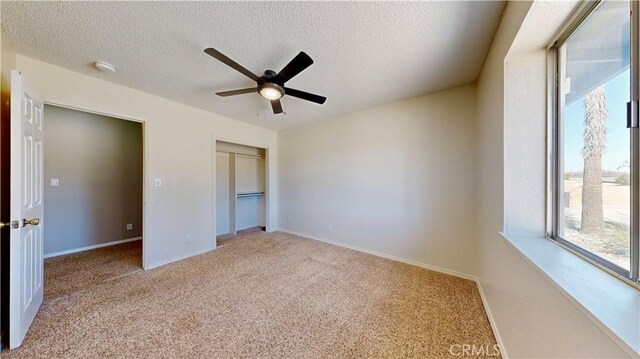 19171 Carlisle Rd, Apple Valley, CA 92307 - unfurnished bedroom featuring carpet floors, a textured ceiling, a closet, and ceiling fan
