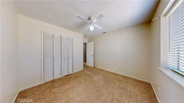 19171 Carlisle Rd, Apple Valley, CA 92307 - unfurnished bedroom featuring light carpet, a closet, a textured ceiling, and ceiling fan