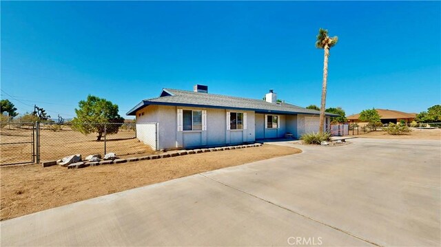 19171 Carlisle Rd, Apple Valley, CA 92307 - ranch-style home featuring concrete driveway, a garage, and a chimney