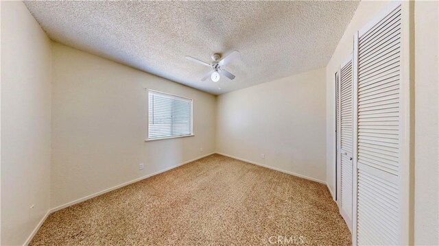 19171 Carlisle Rd, Apple Valley, CA 92307 - unfurnished bedroom featuring a closet, light carpet, a textured ceiling, and a ceiling fan