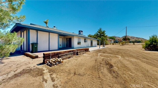 19171 Carlisle Rd, Apple Valley, CA 92307 - back of house with a patio and a mountain view