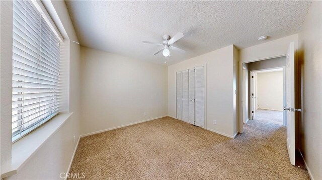 19171 Carlisle Rd, Apple Valley, CA 92307 - unfurnished bedroom featuring light colored carpet, a closet, a textured ceiling, and ceiling fan