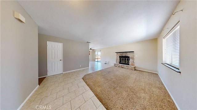 19171 Carlisle Rd, Apple Valley, CA 92307 - unfurnished living room with a fireplace, ceiling fan, and light tile patterned flooring