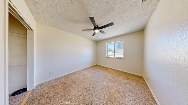 19171 Carlisle Rd, Apple Valley, CA 92307 - unfurnished bedroom featuring light colored carpet, a textured ceiling, a closet, and a ceiling fan