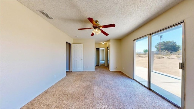 19171 Carlisle Rd, Apple Valley, CA 92307 - unfurnished bedroom featuring access to outside, light carpet, a textured ceiling, and ceiling fan