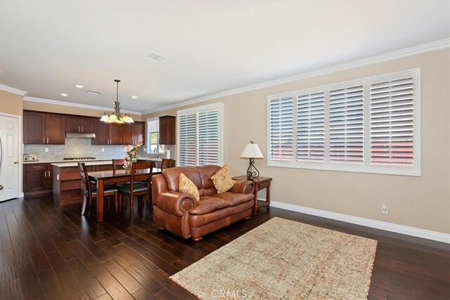 7509 Woodstream Ct, Rancho Cucamonga, CA 91739 - living area featuring a chandelier, dark wood-style floors, ornamental molding, and recessed lighting