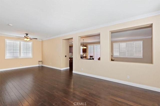 7509 Woodstream Ct, Rancho Cucamonga, CA 91739 - empty room with dark wood-style flooring, a ceiling fan, crown molding, healthy amount of natural light, and a chandelier